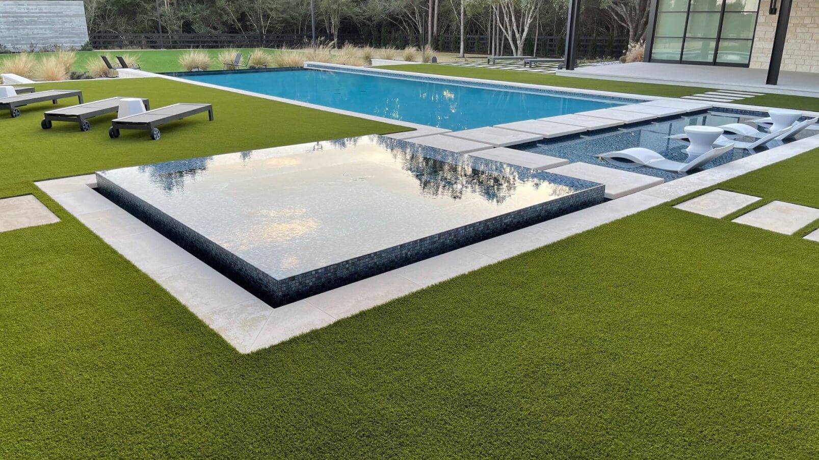 Backyard pool area with SYNLawn artificial grass
