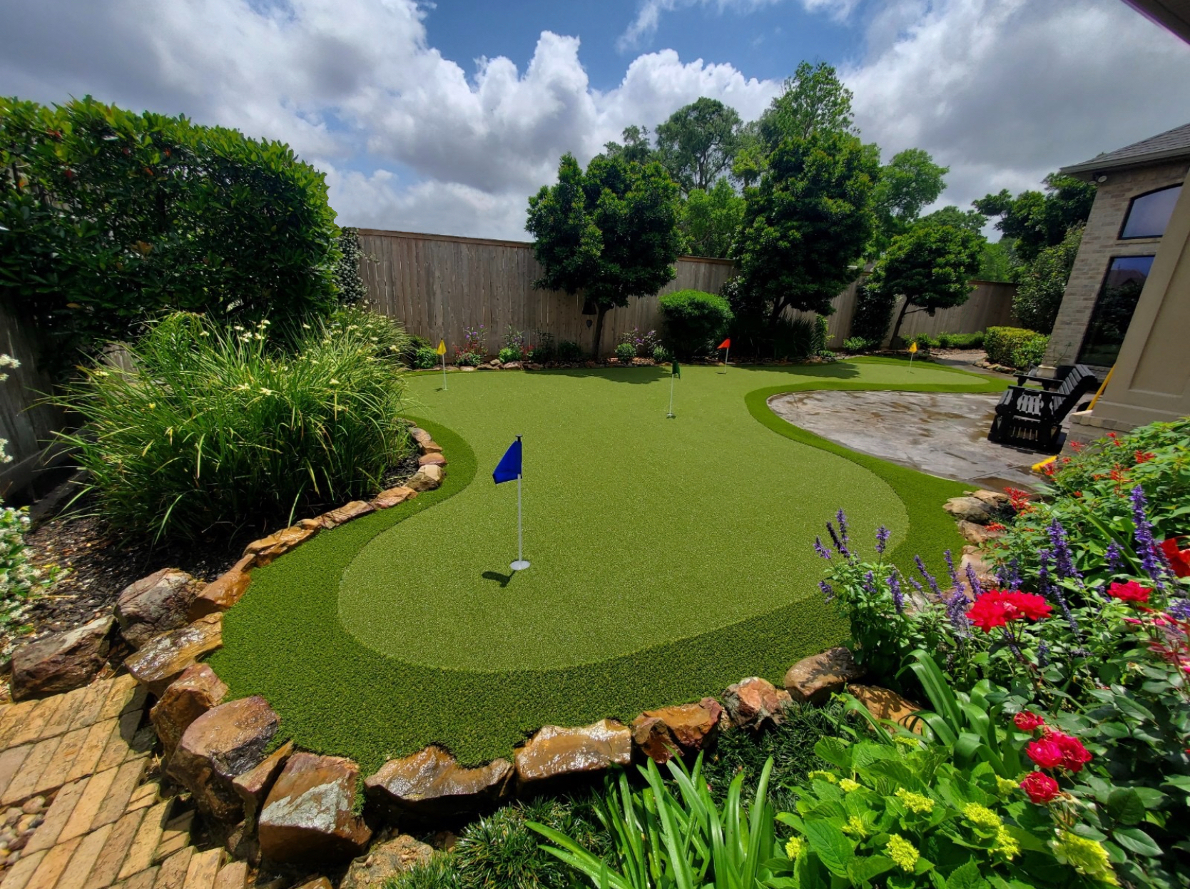 Backyard putting green with blue flag installed by SYNLawn