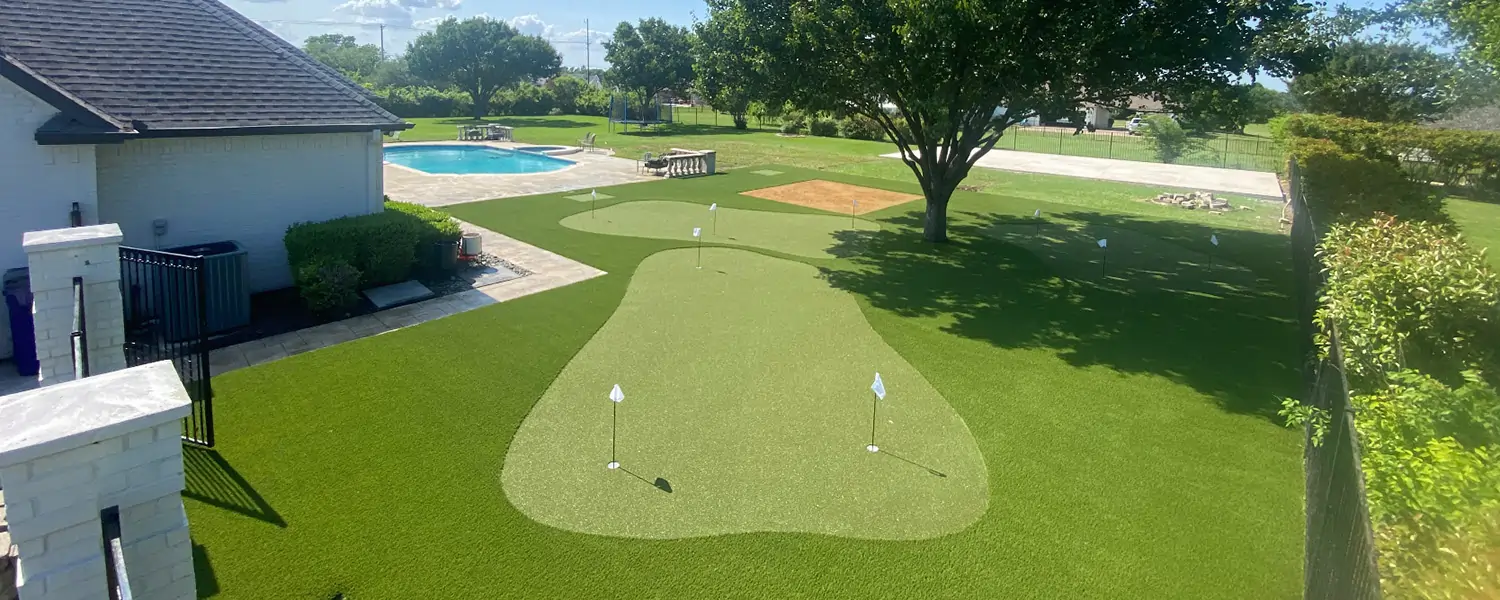 Backyard golf green next to pool area