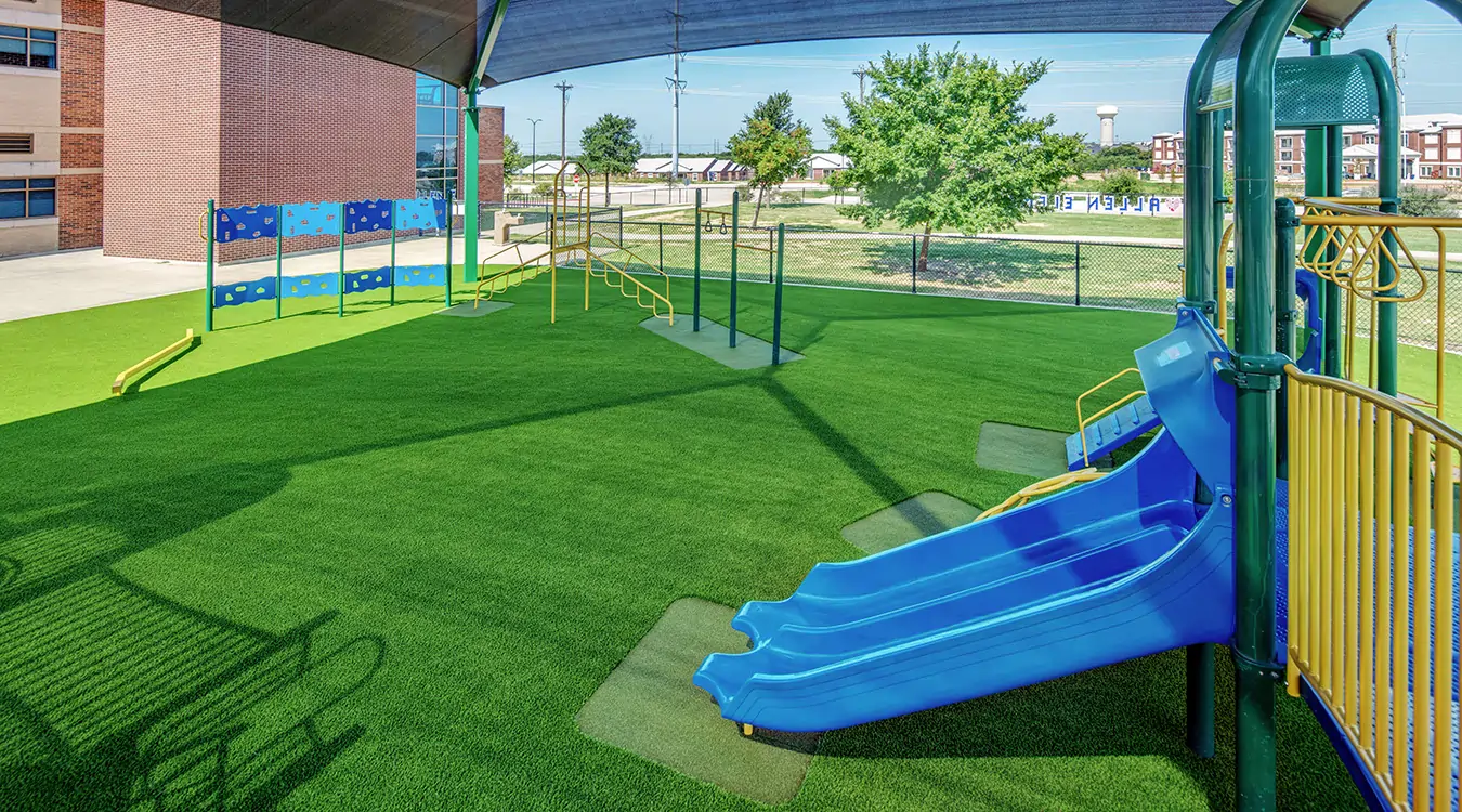 Blue slide on artificial grass playground