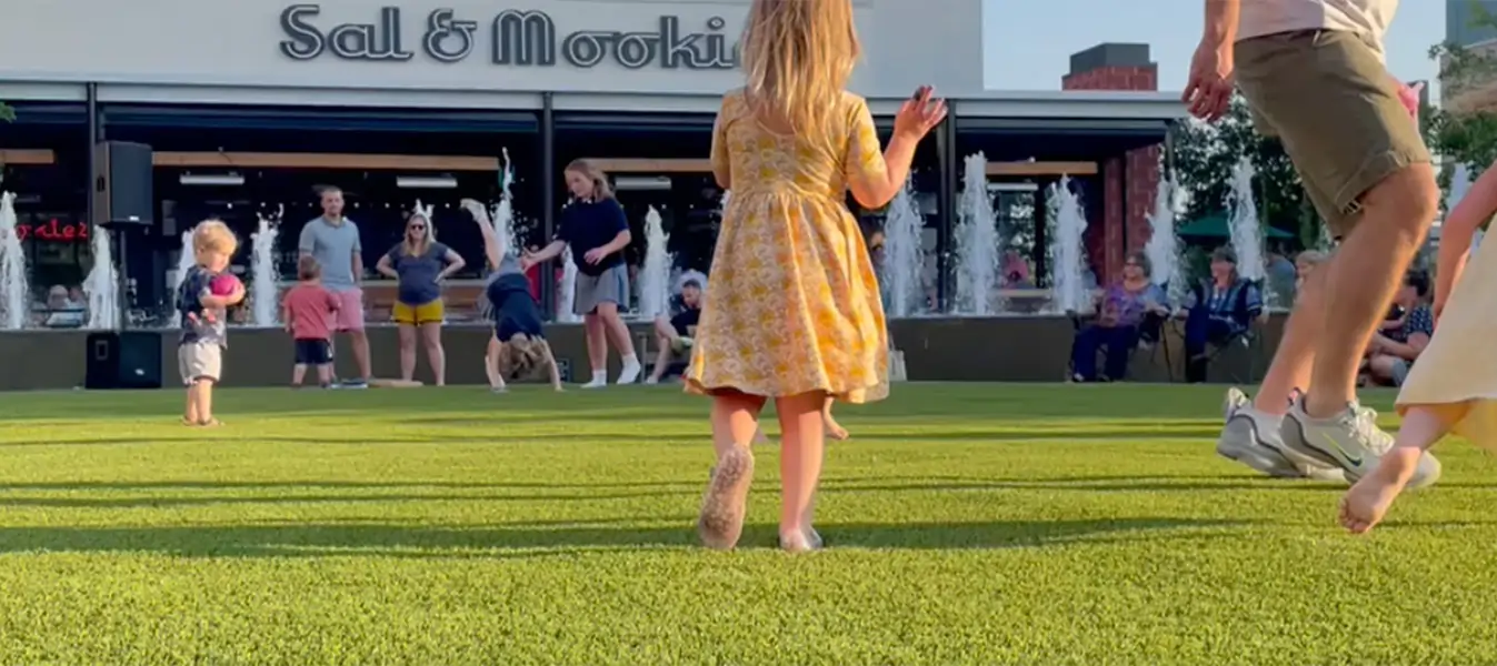 child playing on artificial grass lawn