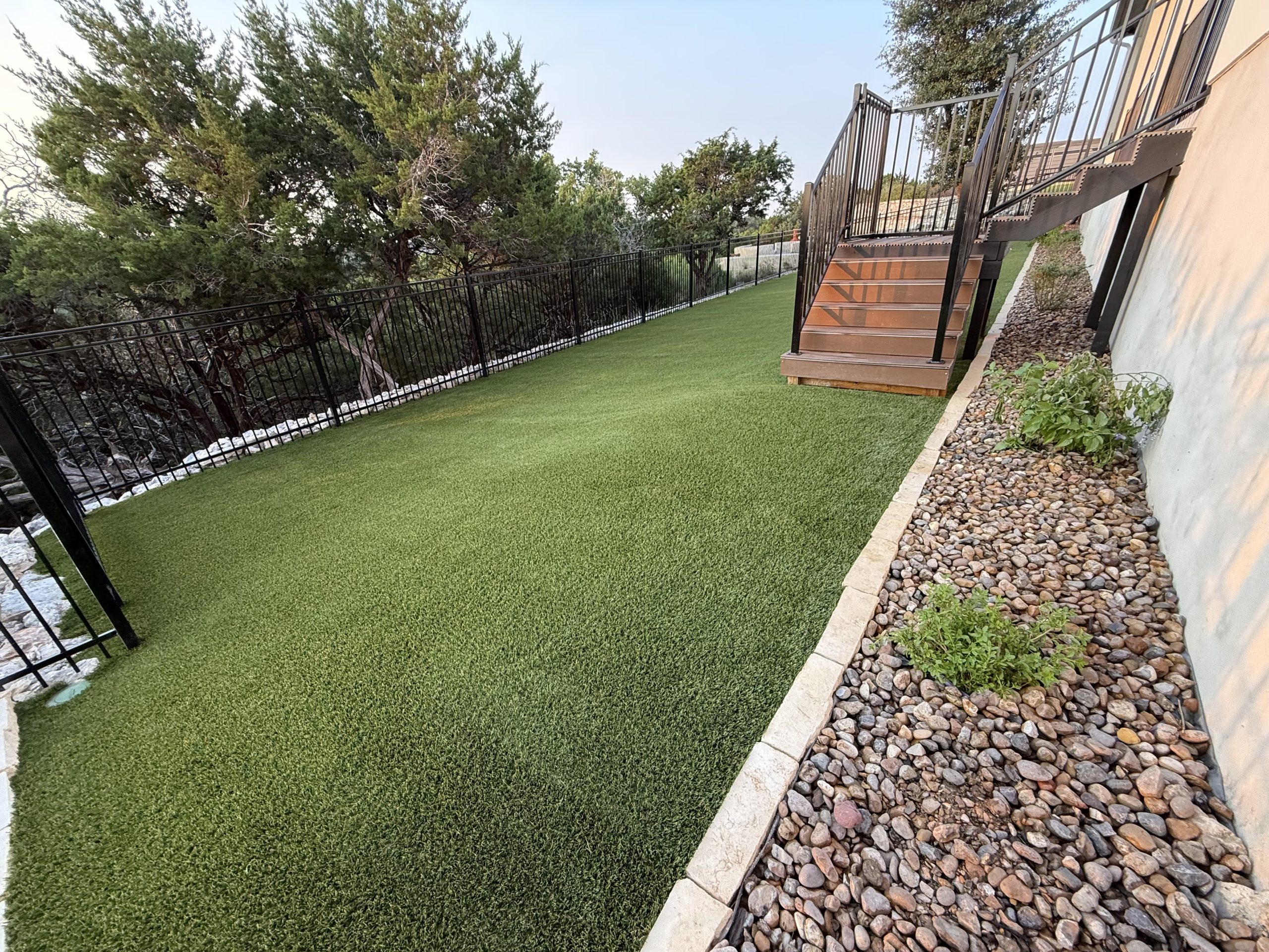 Bay Area Artificial Grass Side Yard with Deck Stairs and Landscape Rock Border Bay Area Artificial Grass Side Yard with Deck Stairs and Landscape Rock Border